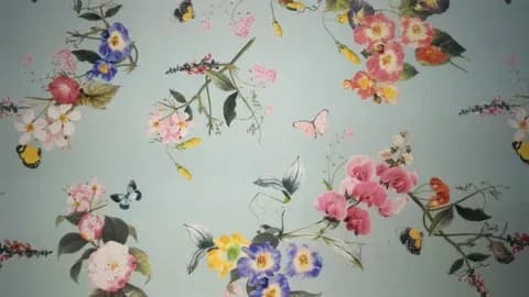 Floral and butterfly print on light blue fabric background