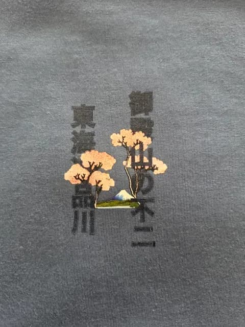 Gray fabric featuring stylized tree and text print